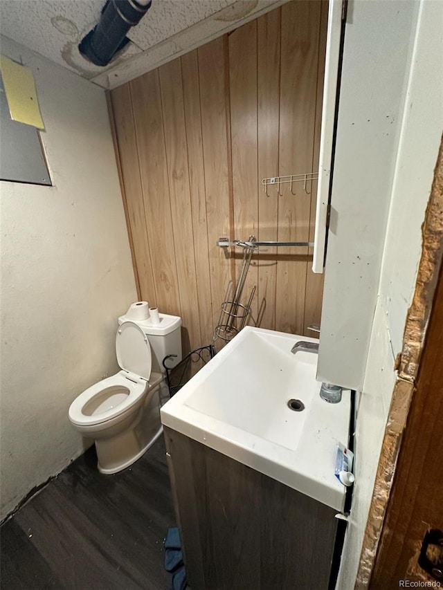 1255 Yates St, Denver, CO 80204 - half bathroom featuring vanity and wood finished floors