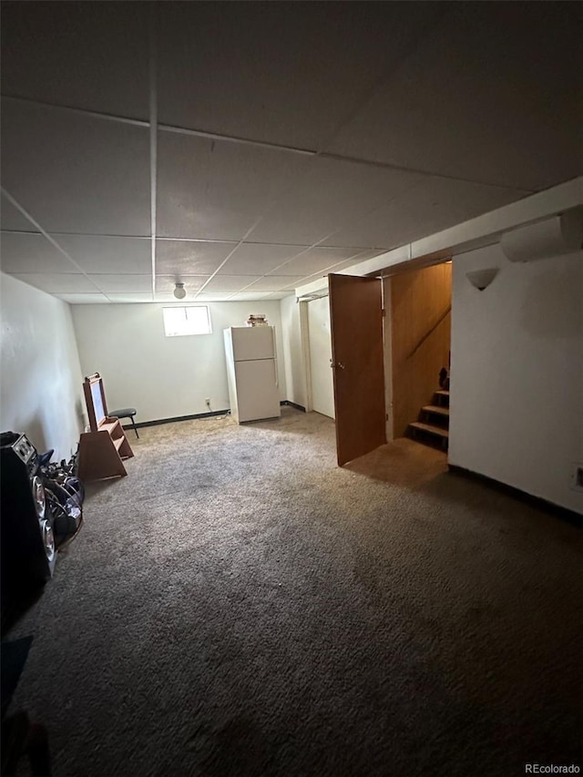 1255 Yates St, Denver, CO 80204 - basement featuring freestanding refrigerator, carpet floors, stairs, and a paneled ceiling