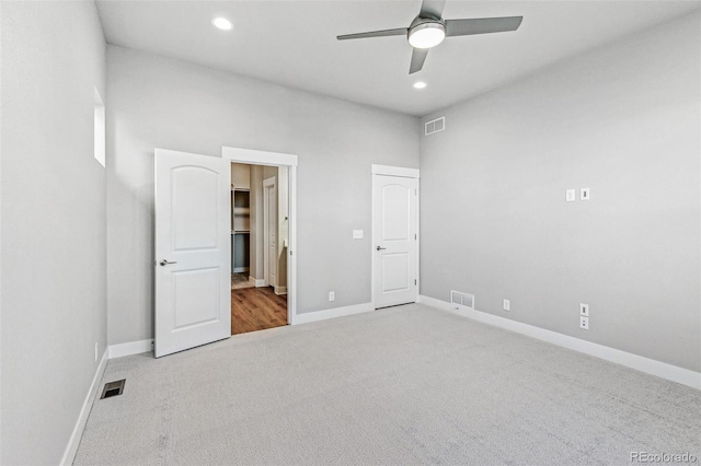 unfurnished bedroom with light colored carpet and ceiling fan