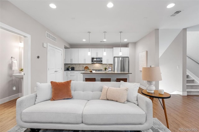 living room with light hardwood / wood-style flooring