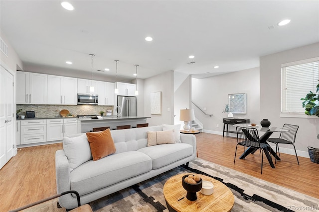 living room with light hardwood / wood-style flooring