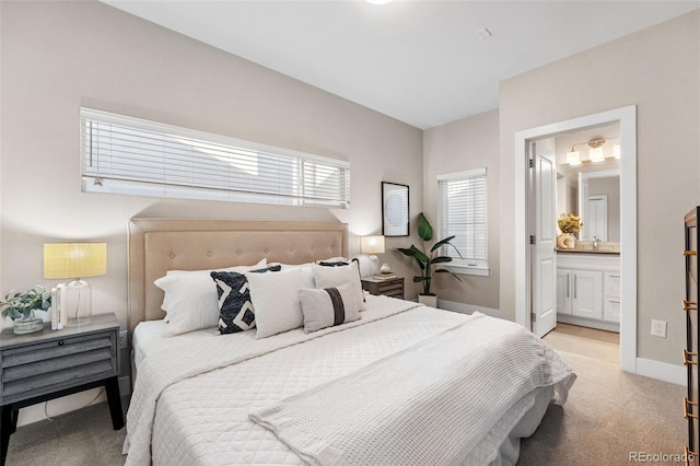 carpeted bedroom featuring ensuite bathroom