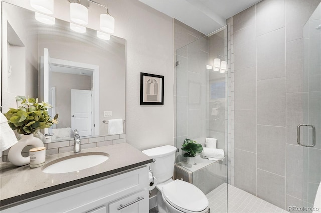 bathroom with vanity, toilet, and an enclosed shower