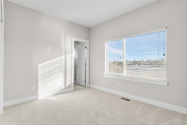 unfurnished bedroom with light colored carpet