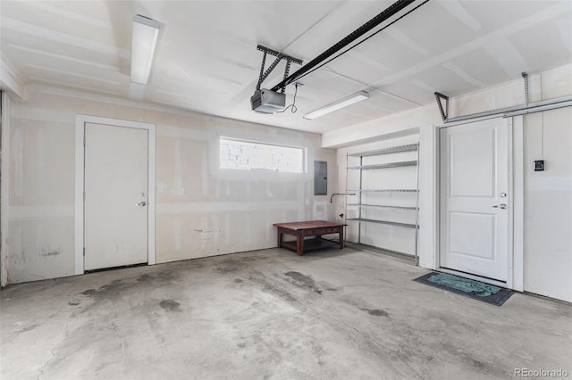 garage with a garage door opener and electric panel