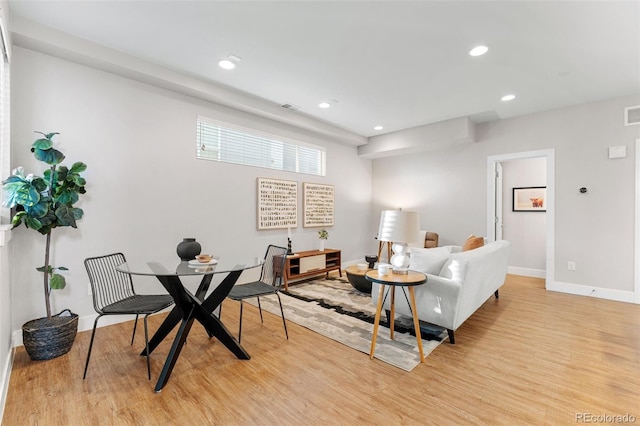 living area featuring recessed lighting, light wood-style flooring, visible vents, and baseboards
