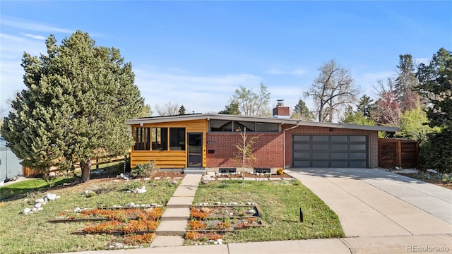 3035 E Maplewood Ave, Centennial, CO 80121 - contemporary house featuring a garage, fence, a chimney, brick siding, and driveway