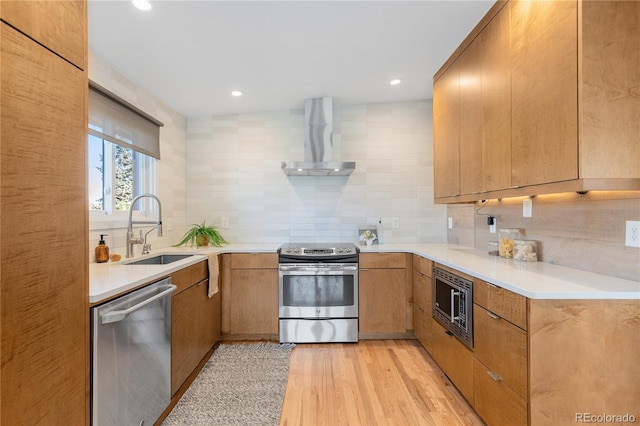 3035 E Maplewood Ave, Centennial, CO 80121 - kitchen featuring tasteful backsplash, light wood-type flooring, a sink, stainless steel appliances, and wall chimney exhaust hood