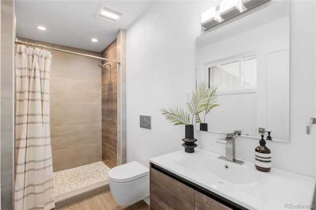 3035 E Maplewood Ave, Centennial, CO 80121 - full bath featuring visible vents, wood finished floors, vanity, toilet, and tiled shower