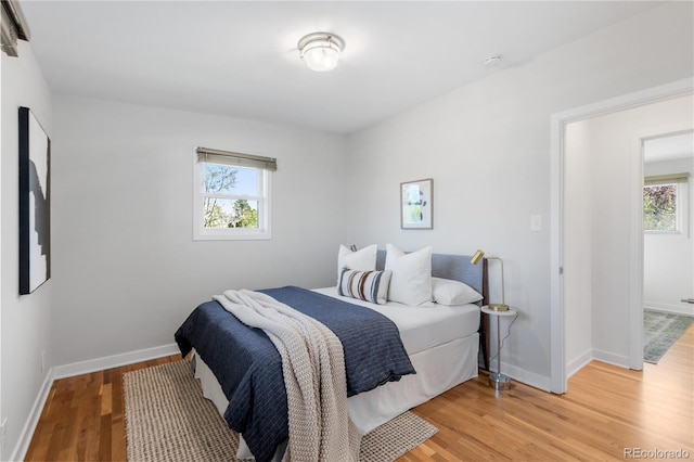 3035 E Maplewood Ave, Centennial, CO 80121 - bedroom featuring baseboards, multiple windows, and light wood-style flooring
