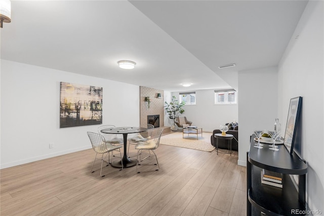 3035 E Maplewood Ave, Centennial, CO 80121 - dining space with light wood-style floors, visible vents, baseboards, and a fireplace