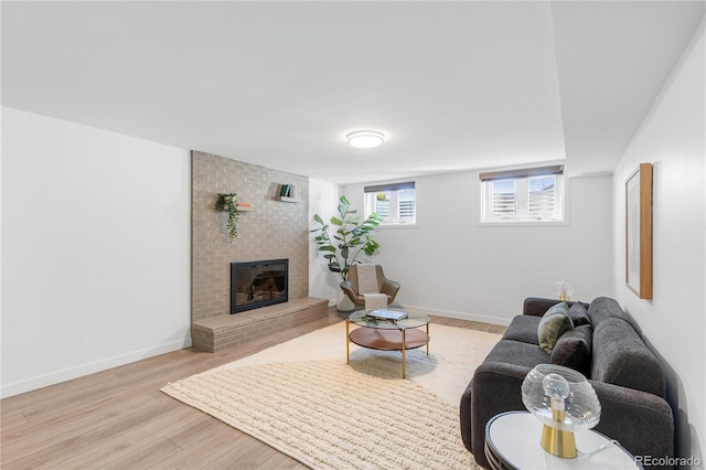 3035 E Maplewood Ave, Centennial, CO 80121 - living room with baseboards, a brick fireplace, and wood finished floors