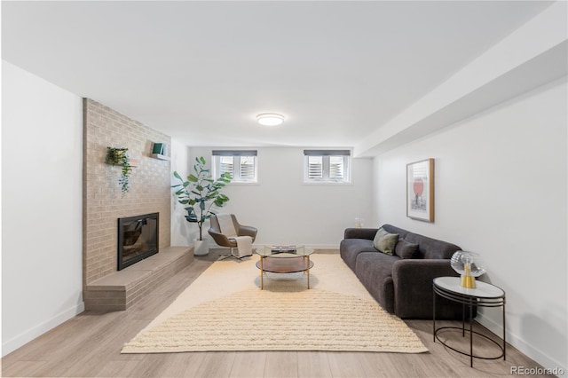 3035 E Maplewood Ave, Centennial, CO 80121 - living room featuring light wood-type flooring, baseboards, and a brick fireplace