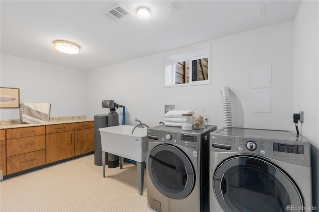 3035 E Maplewood Ave, Centennial, CO 80121 - clothes washing area with visible vents, cabinet space, washing machine and dryer, and light colored carpet