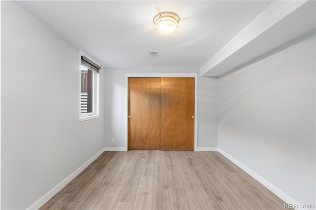 3035 E Maplewood Ave, Centennial, CO 80121 - unfurnished bedroom with baseboards, a closet, wood finished floors, and visible vents