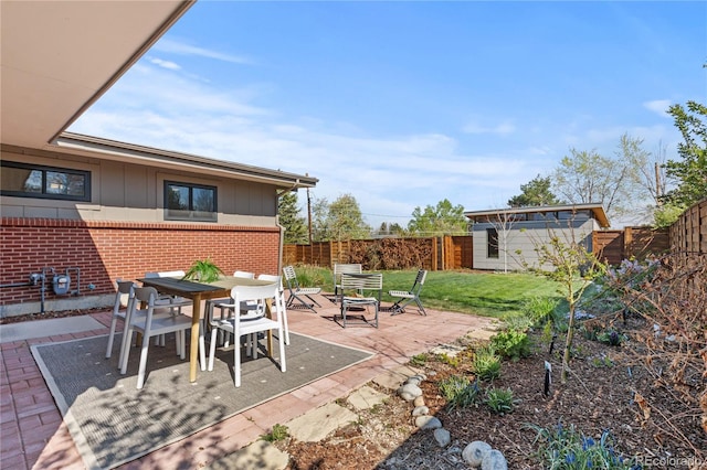 3035 E Maplewood Ave, Centennial, CO 80121 - view of patio / terrace with outdoor dining area, a fenced backyard, and a fire pit