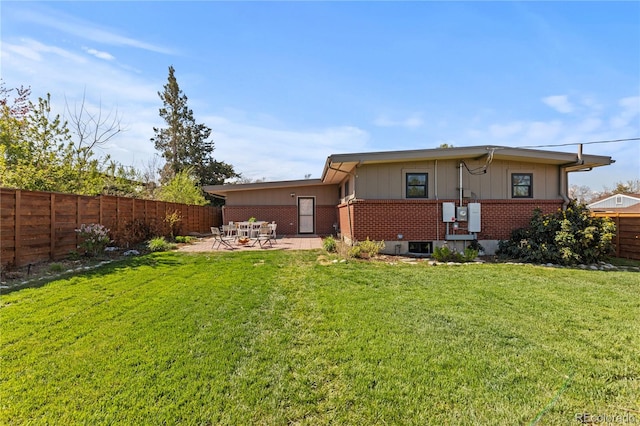 3035 E Maplewood Ave, Centennial, CO 80121 - back of property with a lawn, brick siding, a fenced backyard, and a patio area