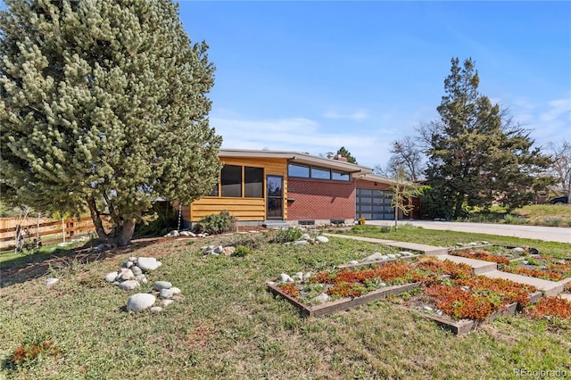 3035 E Maplewood Ave, Centennial, CO 80121 - modern home featuring a garden, driveway, an attached garage, and fence