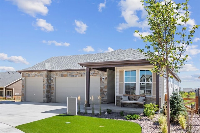 22374 E 49th Pl, Aurora, CO 80019 - view of front of home with concrete driveway, stone siding, a garage, a shingled roof, and a porch