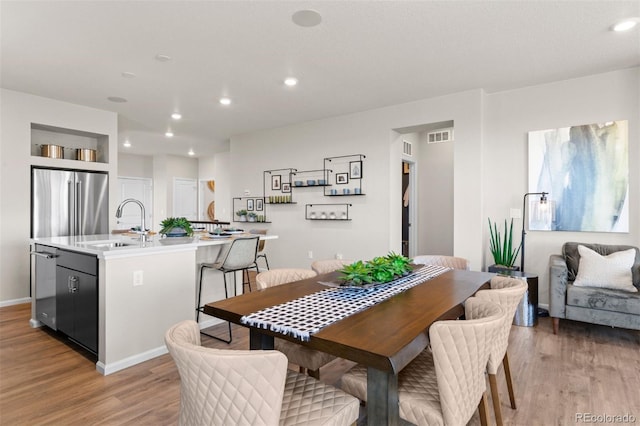 22374 E 49th Pl, Aurora, CO 80019 - dining space featuring light wood finished floors and recessed lighting