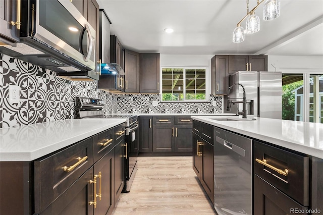 13010 W 6th Pl, Golden, CO 80401 - kitchen featuring appliances with stainless steel finishes, a sink, light countertops, healthy amount of natural light, and recessed lighting