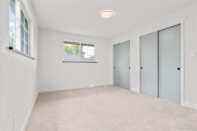 13010 W 6th Pl, Golden, CO 80401 - unfurnished bedroom with two closets, carpet flooring, and baseboards