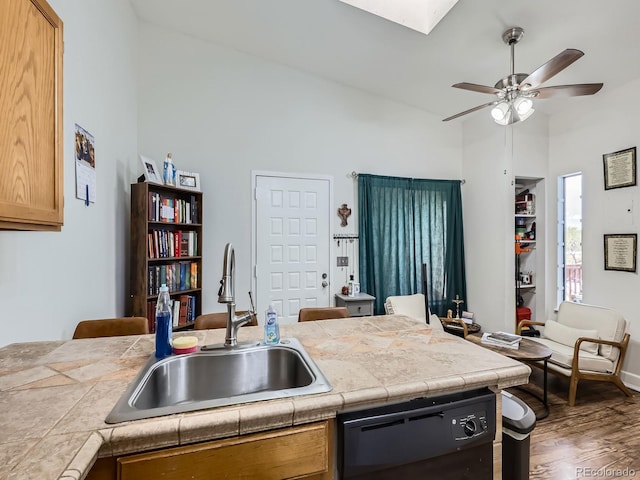 962 S Dearborn Way Unit 19, Aurora, CO 80012 - kitchen featuring a sink, black dishwasher, wood finished floors, high vaulted ceiling, and ceiling fan