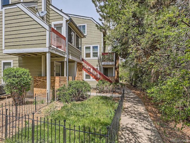 962 S Dearborn Way Unit 19, Aurora, CO 80012 - exterior space featuring fence, stairs, brick siding, and a balcony