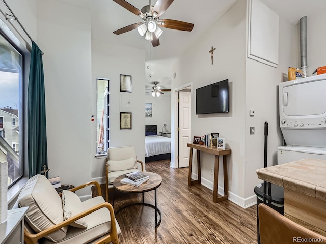 962 S Dearborn Way Unit 19, Aurora, CO 80012 - living room with stacked washer / dryer, wood finished floors, a ceiling fan, high vaulted ceiling, and baseboards