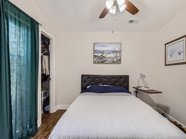 962 S Dearborn Way Unit 19, Aurora, CO 80012 - bedroom with a ceiling fan, dark wood finished floors, visible vents, baseboards, and a spacious closet