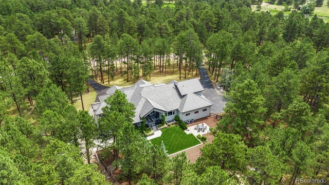 birds eye view of property with a forest view