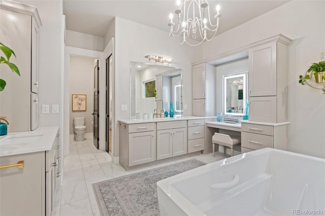 full bathroom featuring two vanities, toilet, marble finish floor, and a sink