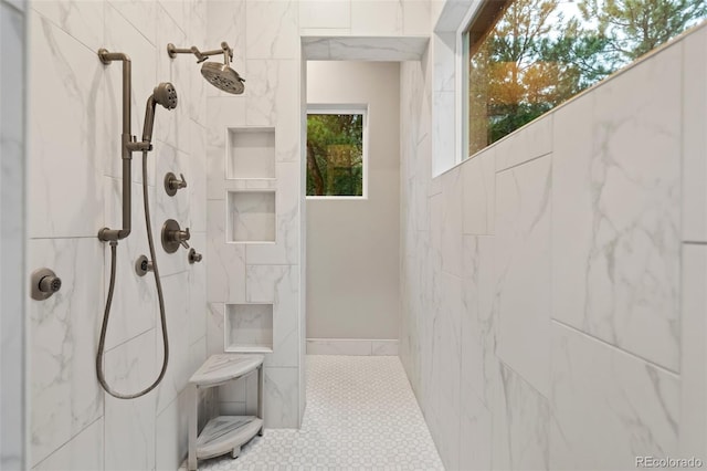 bathroom featuring tile patterned floors and a marble finish shower