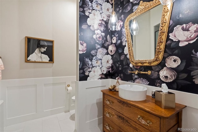 bathroom featuring tile patterned floors, toilet, and vanity