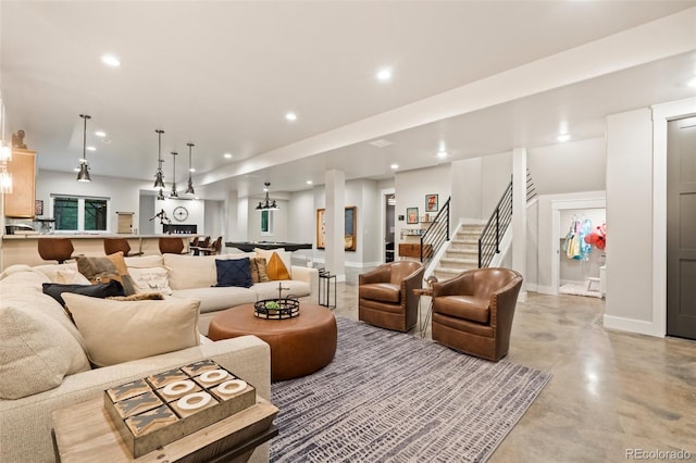 living area with stairway, recessed lighting, concrete flooring, and baseboards