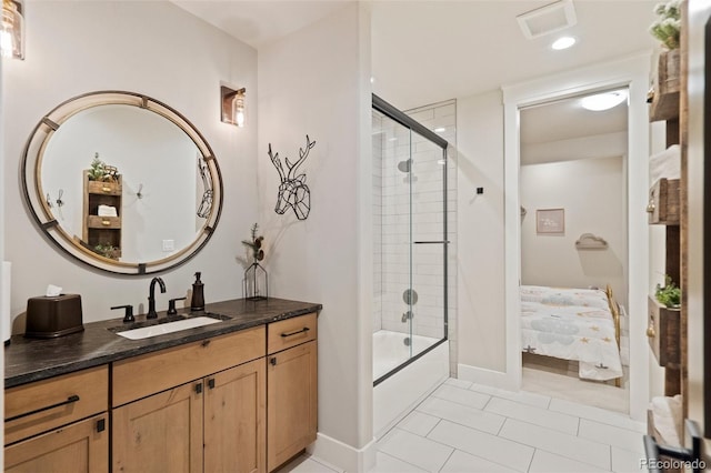 full bath with vanity, visible vents, shower / bath combination with glass door, ensuite bathroom, and tile patterned floors