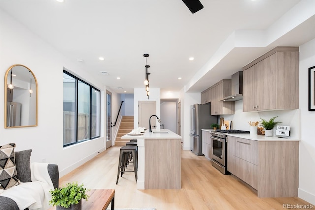 3433 Lawrence St Unit 1, Denver, CO 80205 - kitchen with appliances with stainless steel finishes, modern cabinets, light brown cabinets, light wood-style floors, and recessed lighting