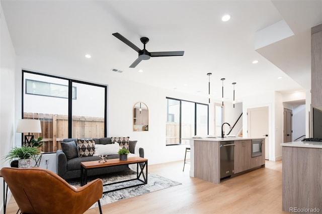 3433 Lawrence St Unit 1, Denver, CO 80205 - living room with light wood-style flooring, ceiling fan, and recessed lighting