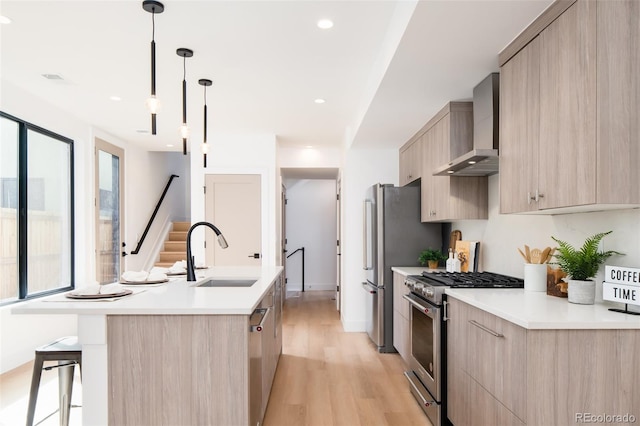 3433 Lawrence St Unit 1, Denver, CO 80205 - kitchen featuring stainless steel appliances, modern cabinets, a sink, light brown cabinetry, and recessed lighting