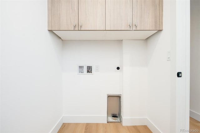 3433 Lawrence St Unit 1, Denver, CO 80205 - clothes washing area featuring hookup for an electric dryer, hookup for a washing machine, cabinet space, light wood-type flooring, and baseboards