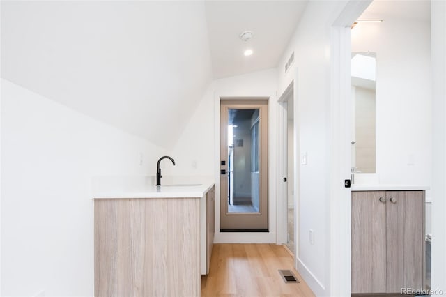 3433 Lawrence St Unit 1, Denver, CO 80205 - bathroom with vanity, lofted ceiling, wood finished floors, and recessed lighting