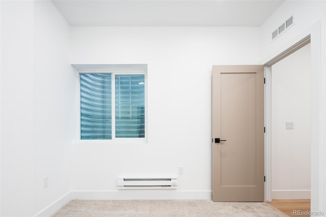 3433 Lawrence St Unit 1, Denver, CO 80205 - empty room featuring baseboard heating, baseboards, and carpet
