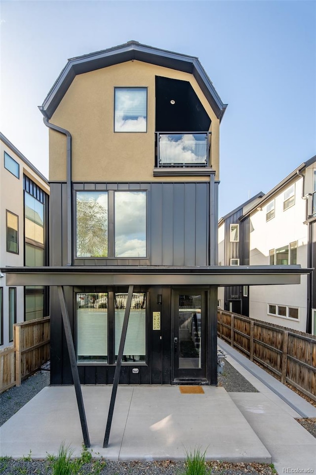 3433 Lawrence St Unit 1, Denver, CO 80205 - view of front of home featuring board and batten siding and fence