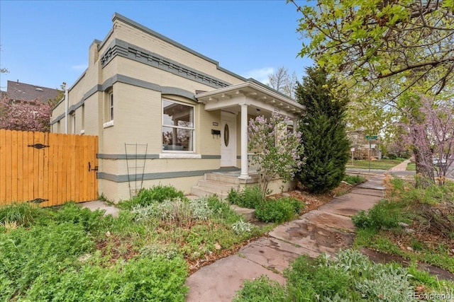 view of front of house with fence and a gate