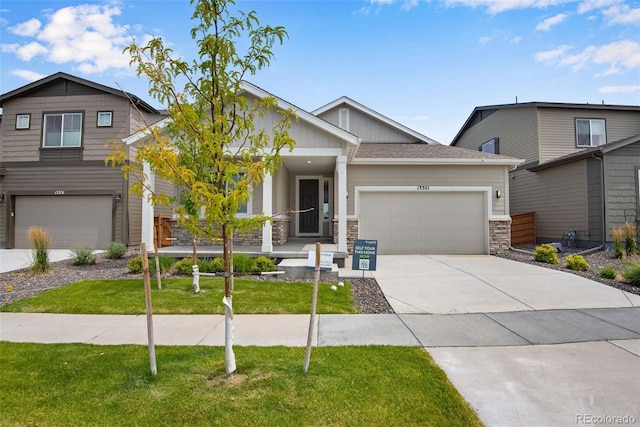 craftsman-style house featuring a garage and a front lawn