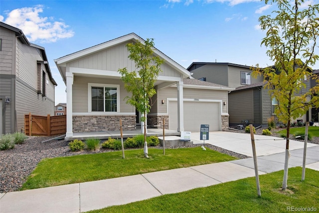 craftsman inspired home with a front yard and a garage