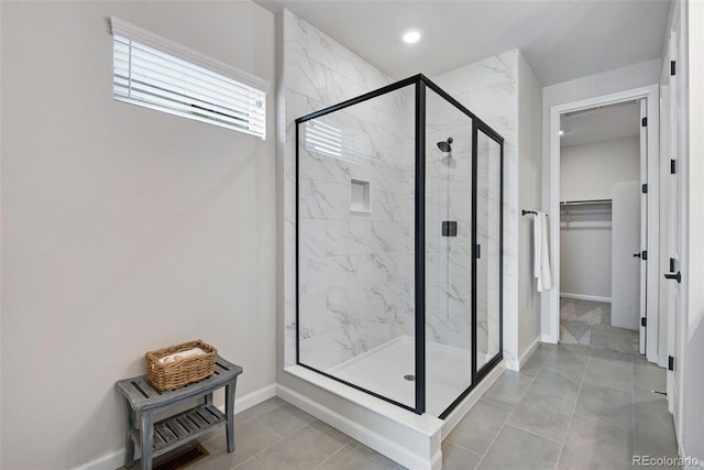 bathroom featuring a shower with door and tile patterned floors