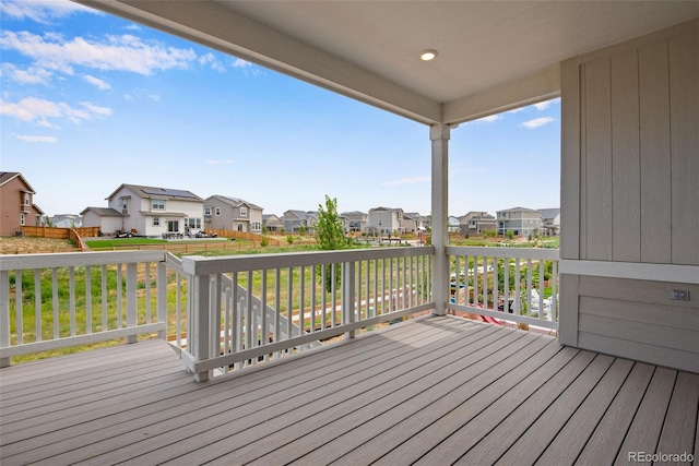 wooden terrace featuring a yard