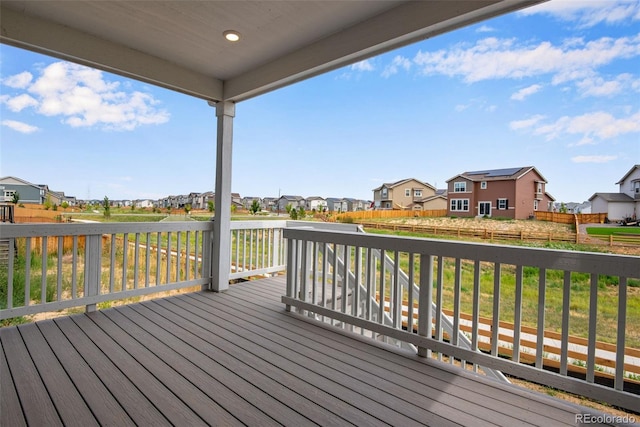 13351 E 100th Pl, Commerce City, CO 80022 - wooden terrace featuring a residential view, fence, and a yard