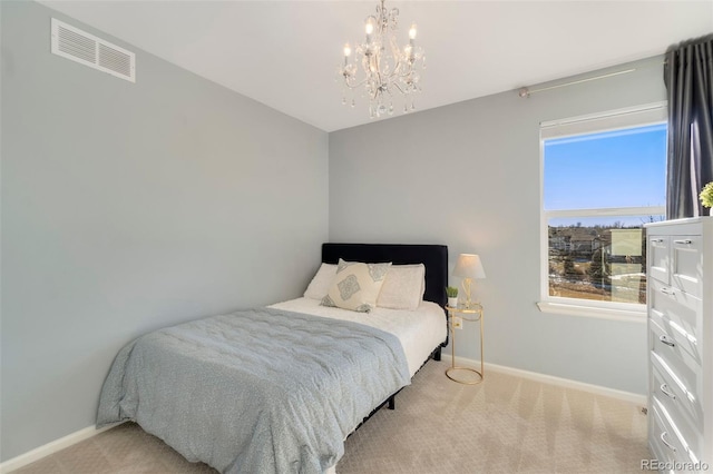 carpeted bedroom with a chandelier